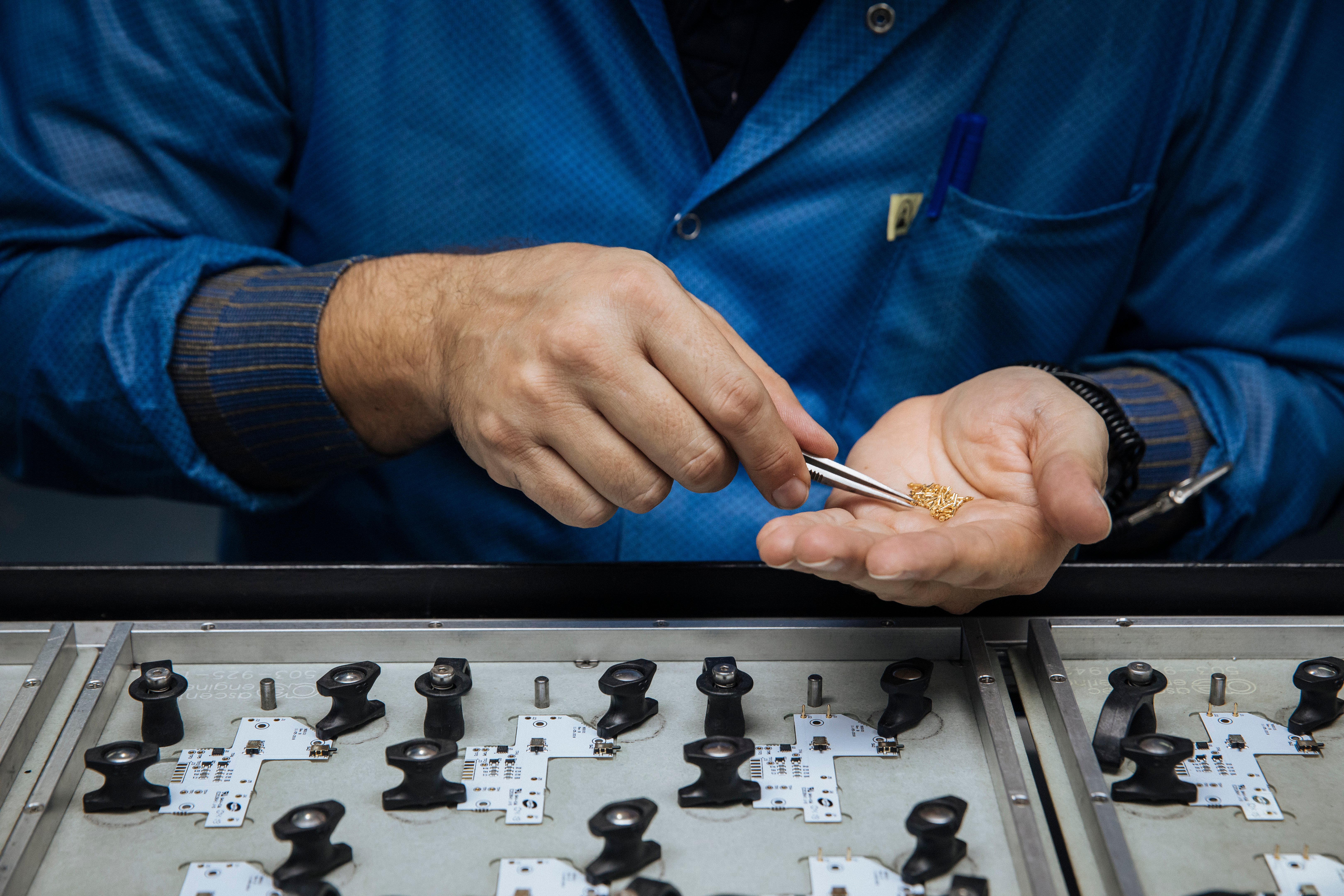 Hands picking up small components