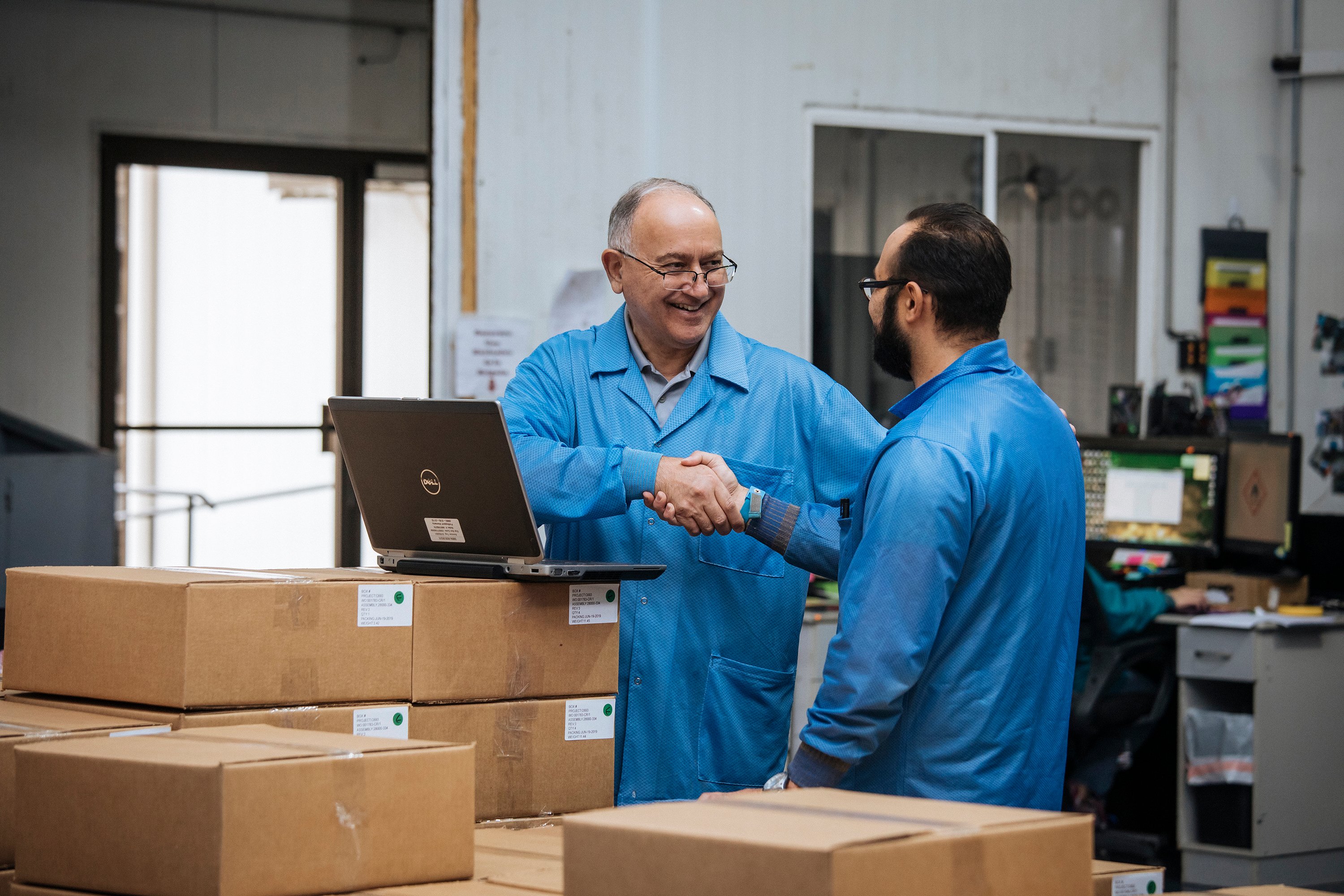 Supplier shaking hands and smiling